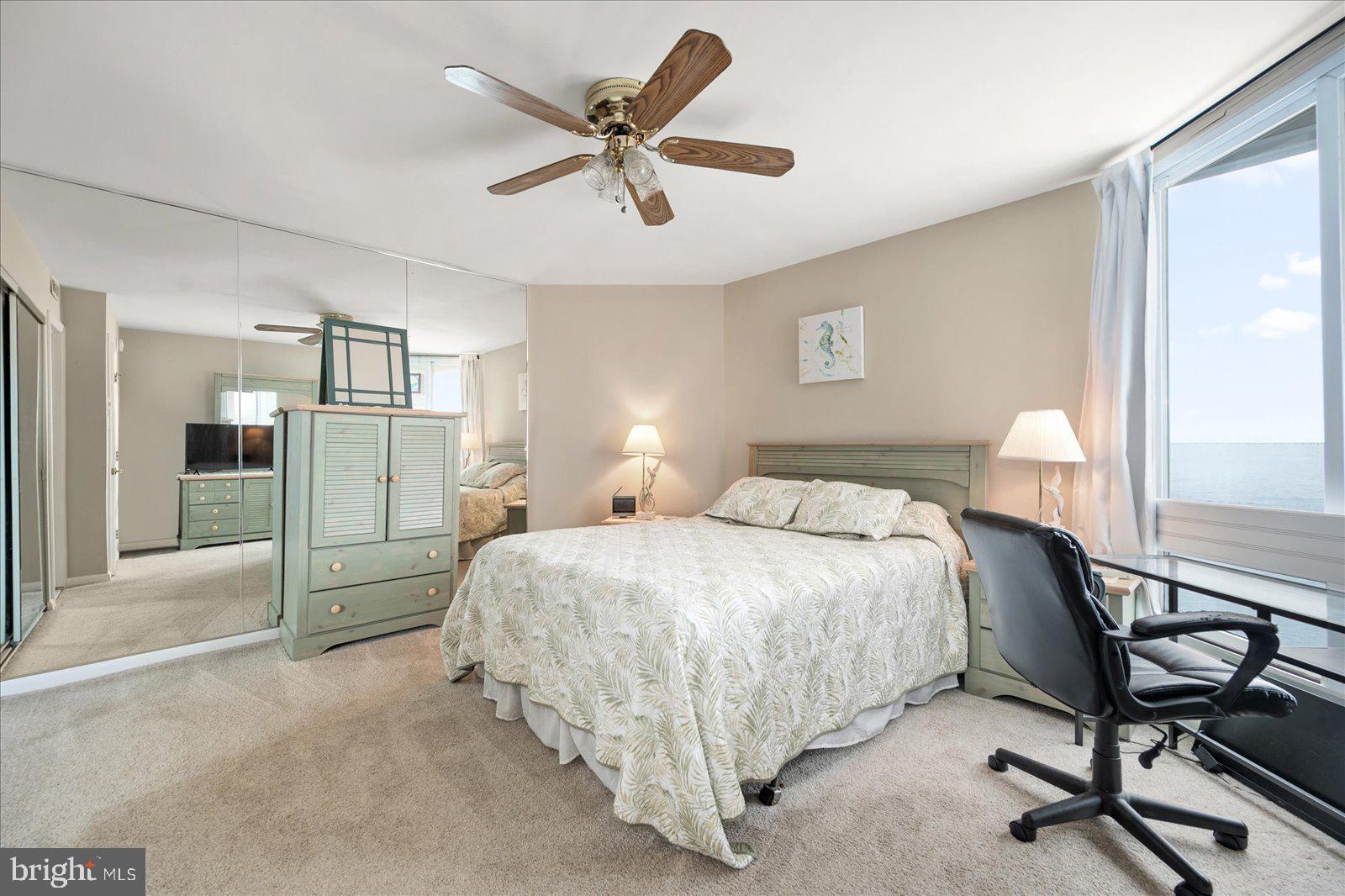 775 94th Street, Unit 775 Ocean City, MD 21842 - Photo 24 of 57 a spacious bedroom with a bed a table and chair