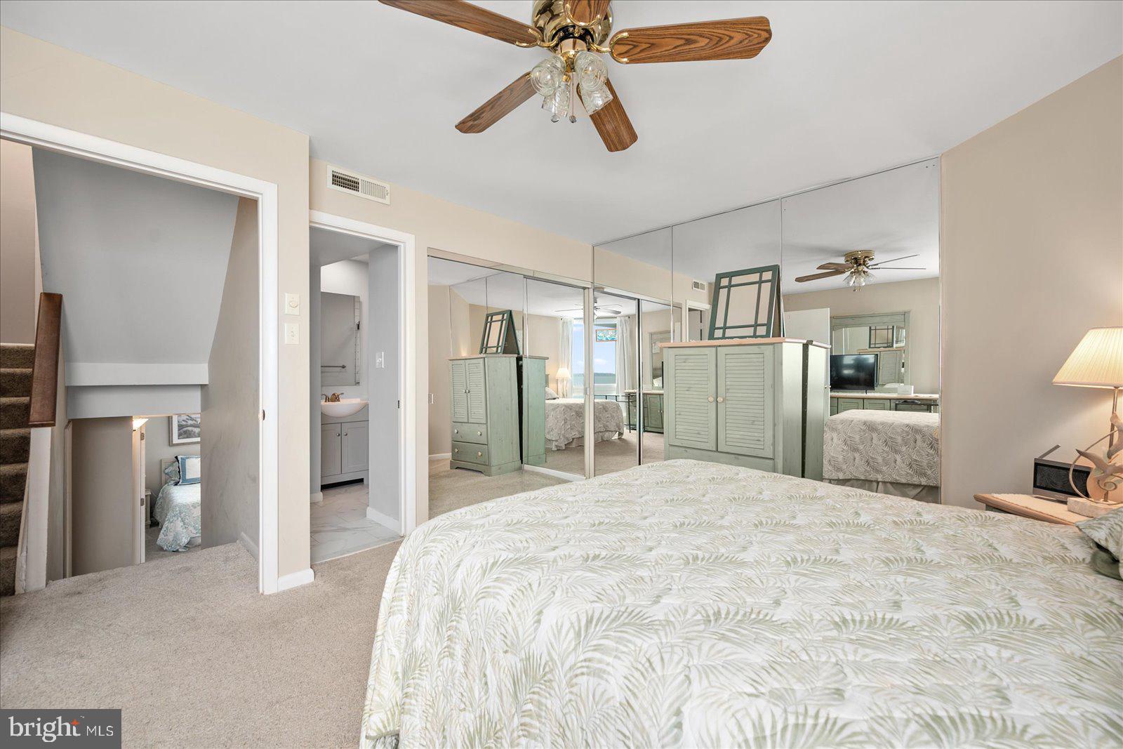 775 94th Street, Unit 775 Ocean City, MD 21842 - Photo 27 of 57 a large bedroom with a bed and a chandelier