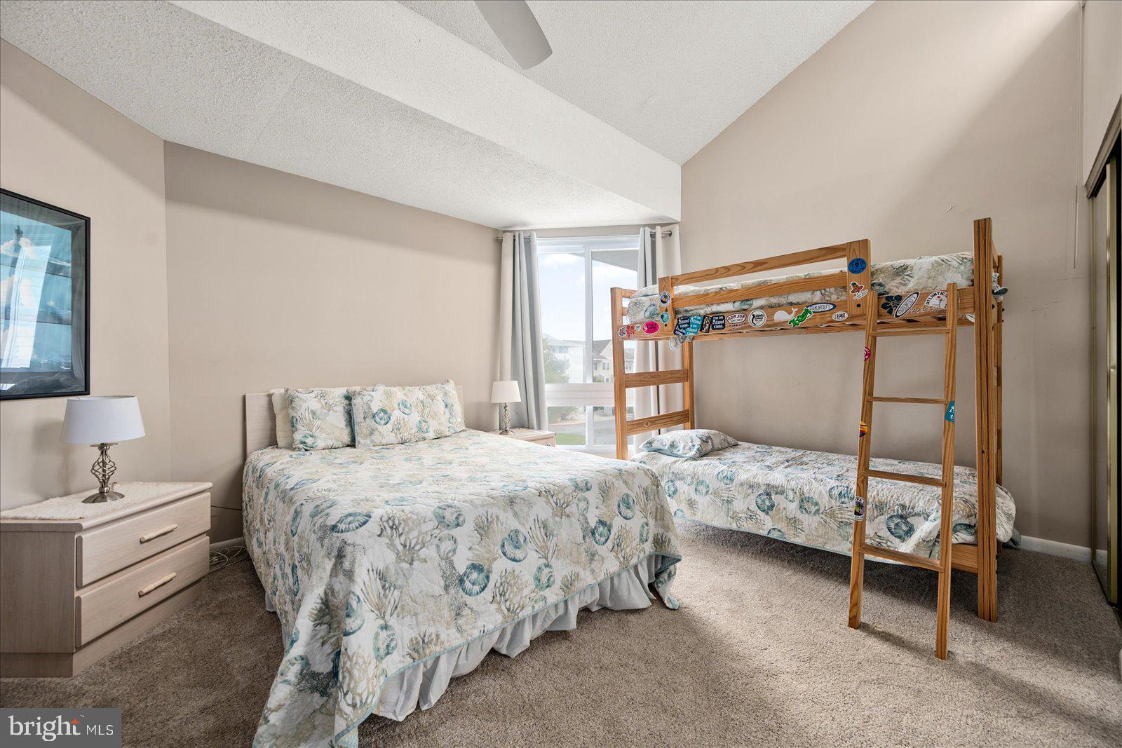 775 94th Street, Unit 775 Ocean City, MD 21842 - Photo 29 of 57 a bedroom with a bed and a mirror