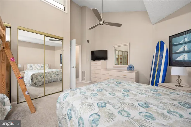 a bedroom with a large bed and a flat screen tv