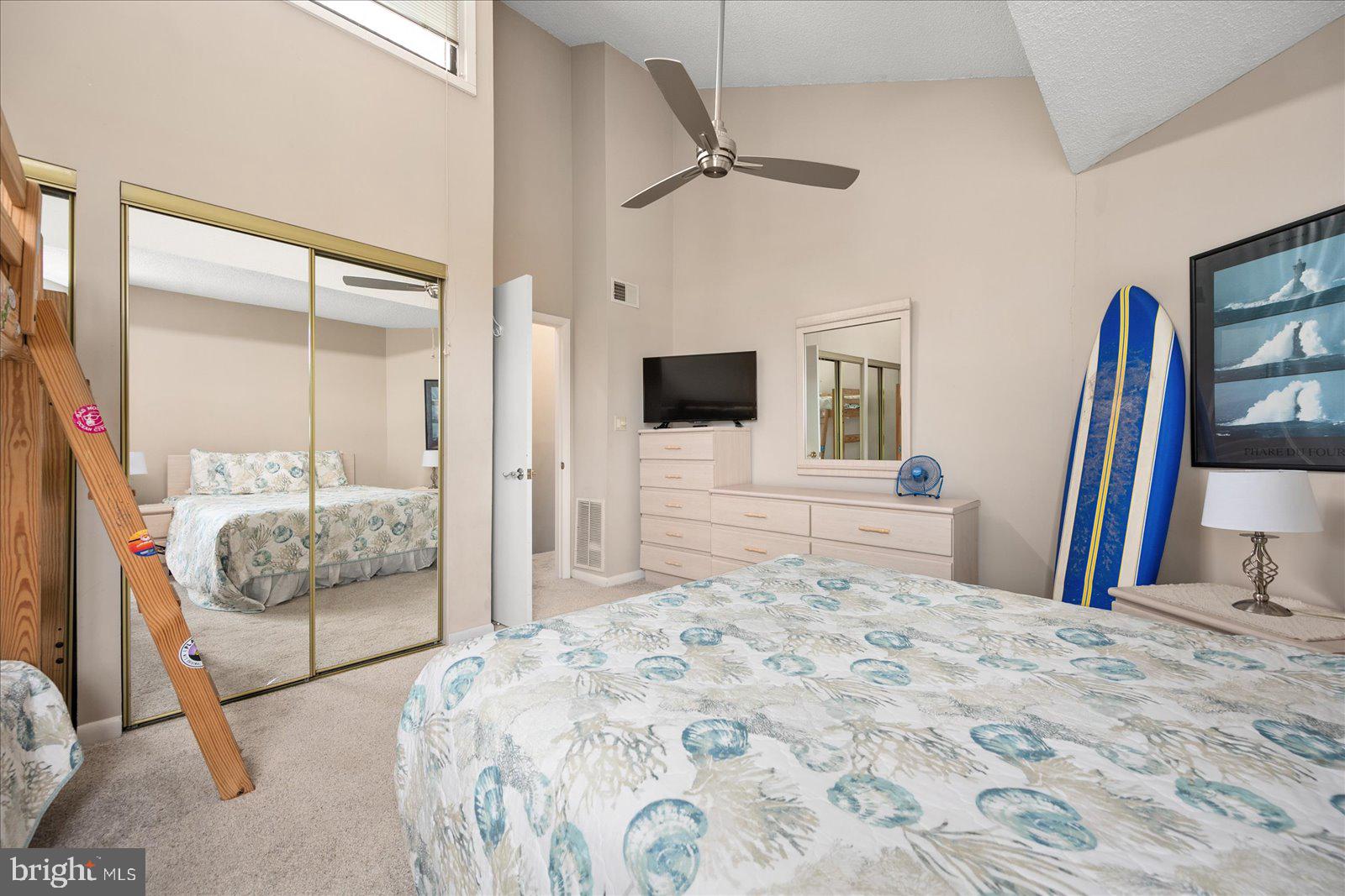 775 94th Street, Unit 775 Ocean City, MD 21842 - Photo 31 of 57 a bedroom with a large bed and a flat screen tv