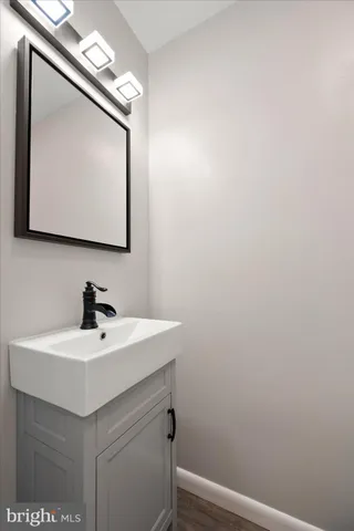 a bathroom with a sink a mirror and vanity