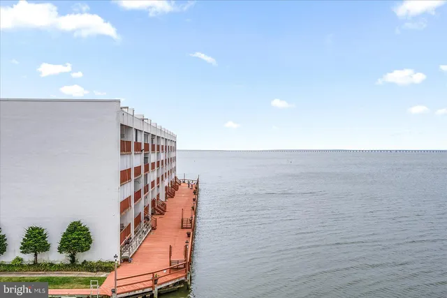 a living room with furniture a rug and kitchen view
