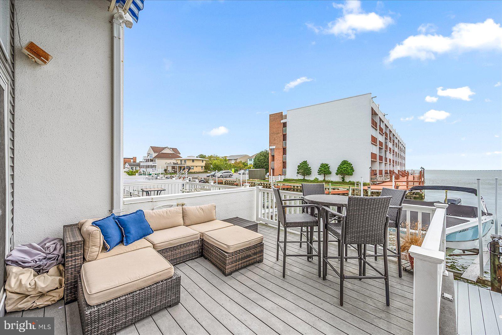 775 94th Street, Unit 775 Ocean City, MD 21842 - Photo 42 of 57 a living room with furniture a rug and kitchen view