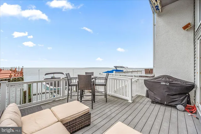 a view of swimming pool with outdoor seating and lake view