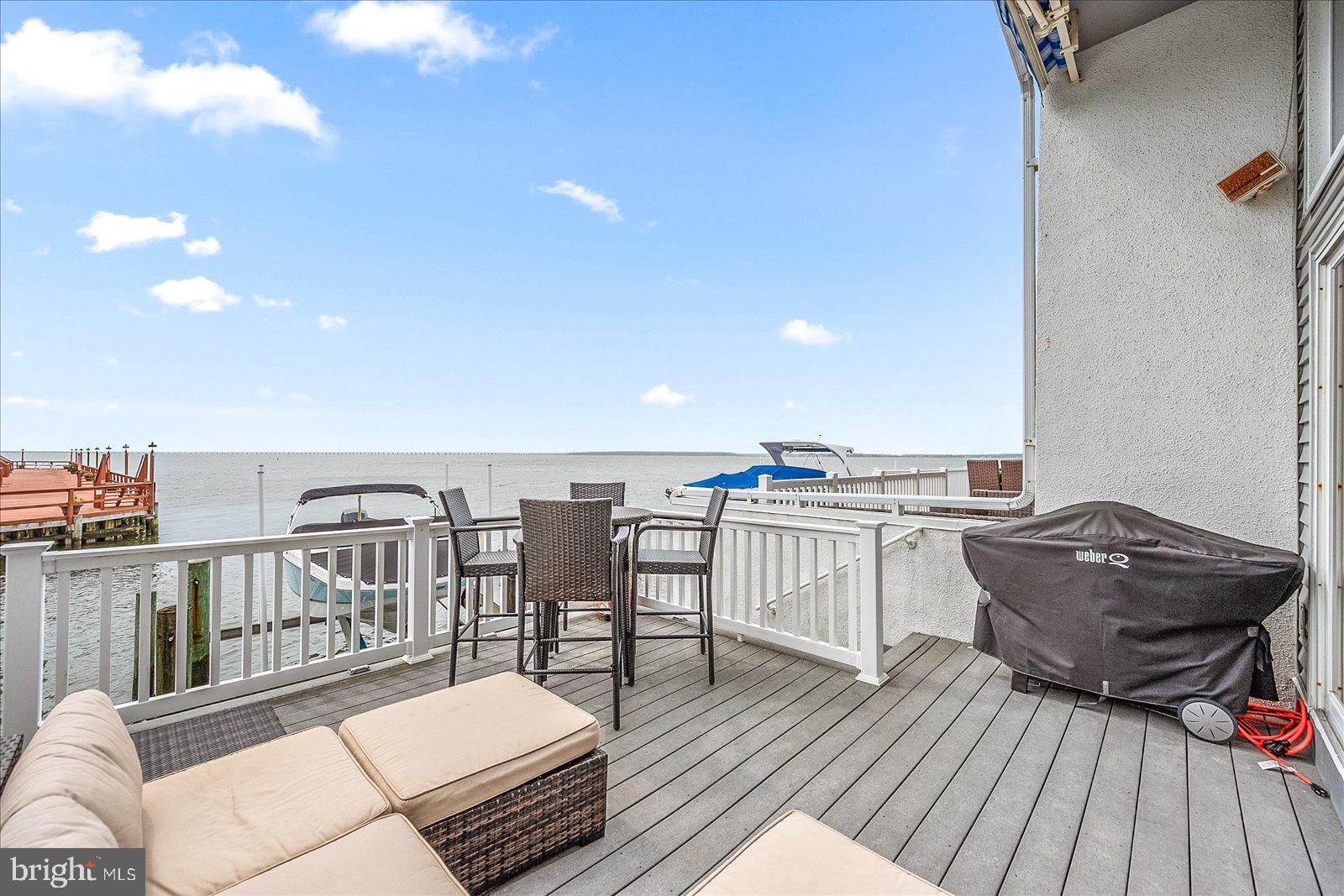775 94th Street, Unit 775 Ocean City, MD 21842 - Photo 43 of 57 a living room with furniture a rug and a table