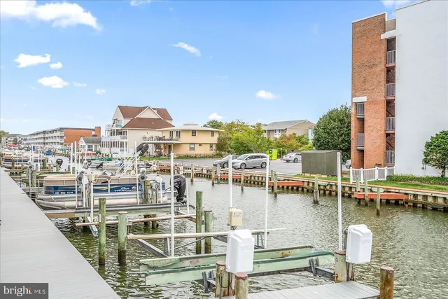 a roof deck with table and chairs a barbeque
