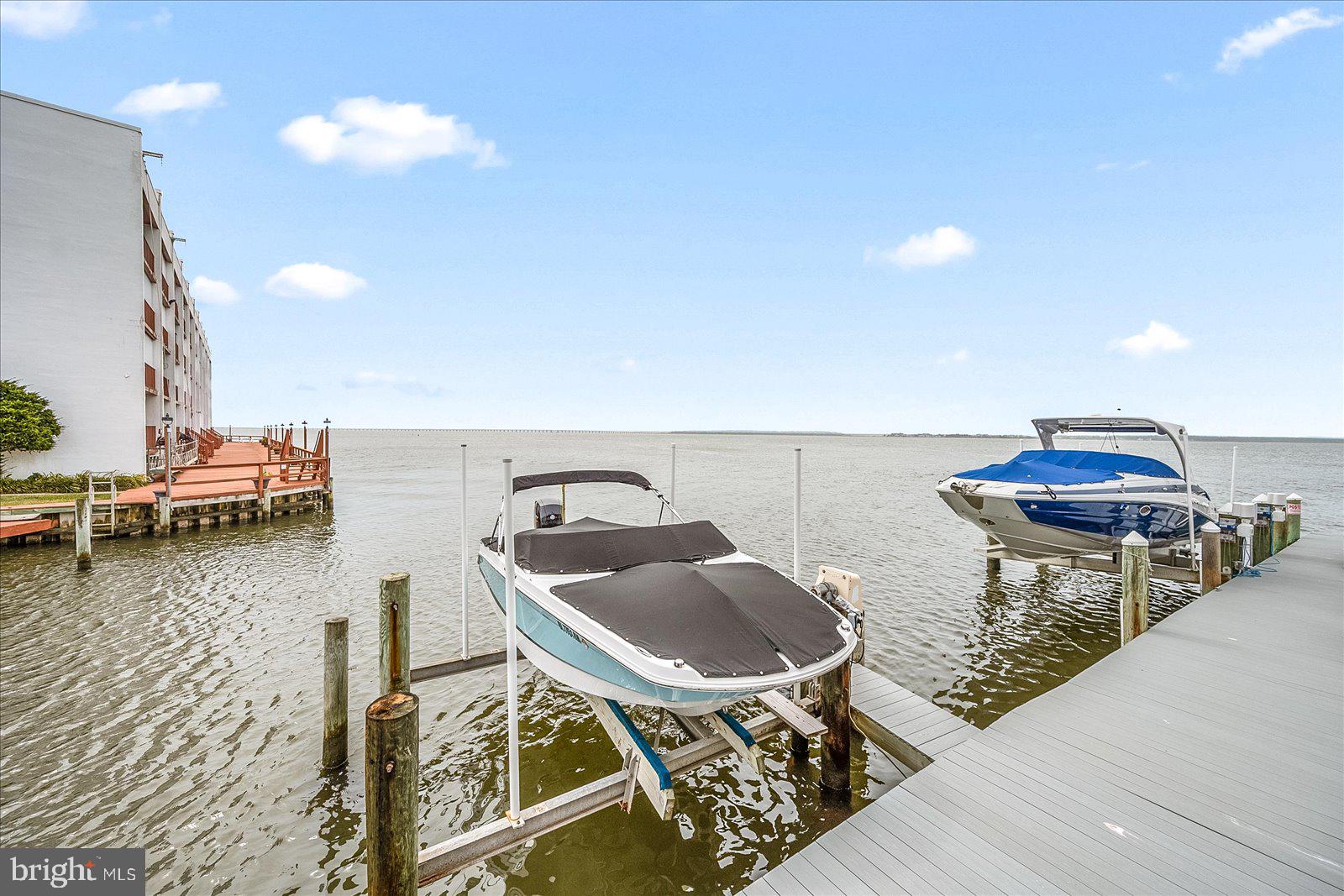 775 94th Street, Unit 775 Ocean City, MD 21842 - Photo 50 of 57 a roof deck with table and chairs a barbeque