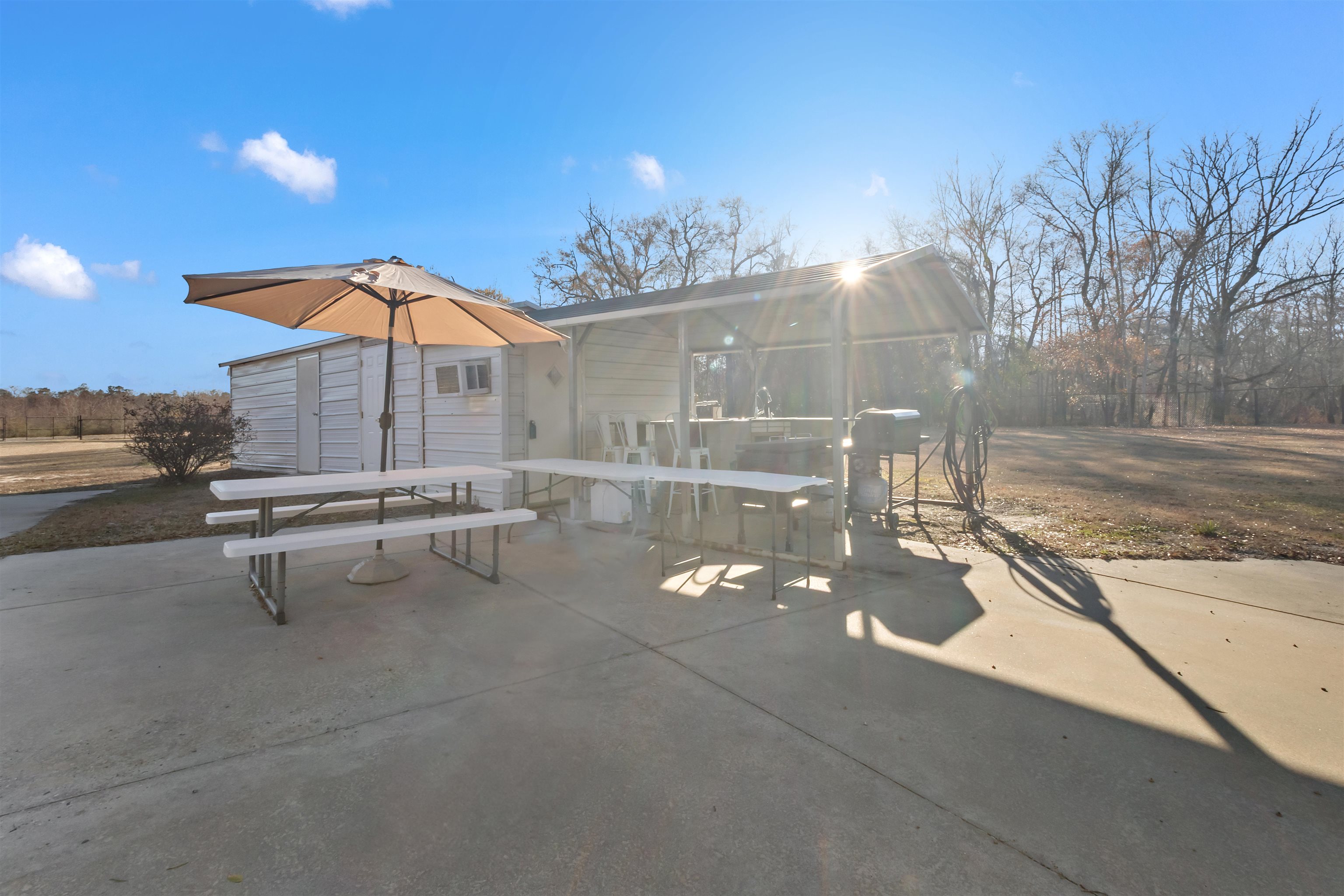 3429 River Road Nichols, SC 29581 - Photo 14 of 46 View of the property featuring fencing, a gazebo and an outbuilding with an outdoor kitchen, bathroom, laundry room and bunk house