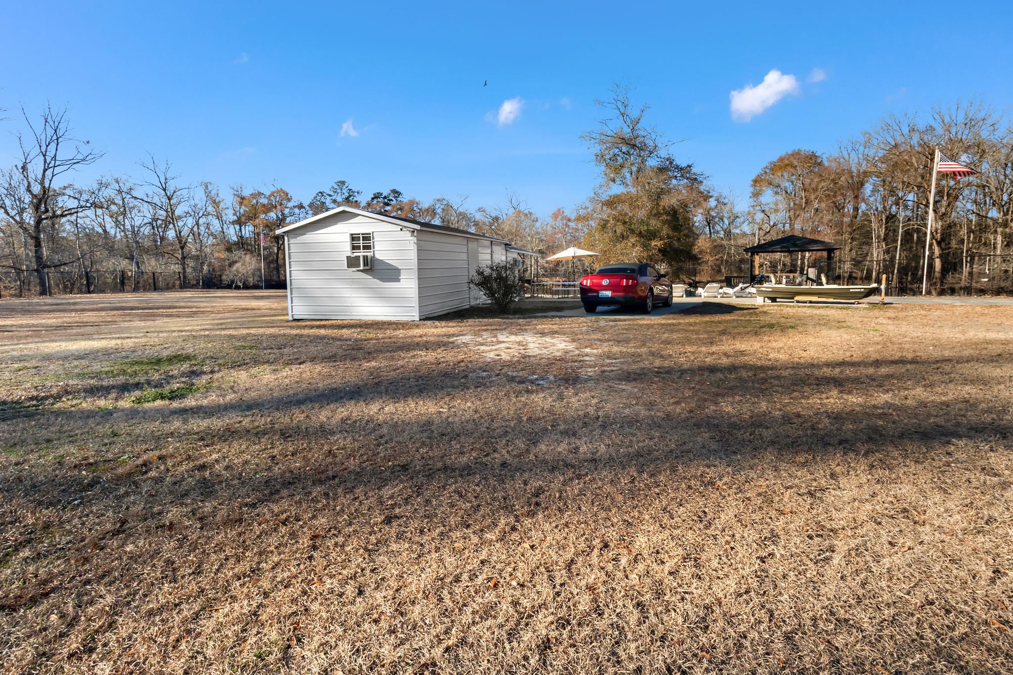 3429 River Road Nichols, SC 29581 - Photo 24 of 46 View of the property featuring fencing, a gazebo and an outbuilding with an outdoor kitchen, bathroom, laundry room and bunk house