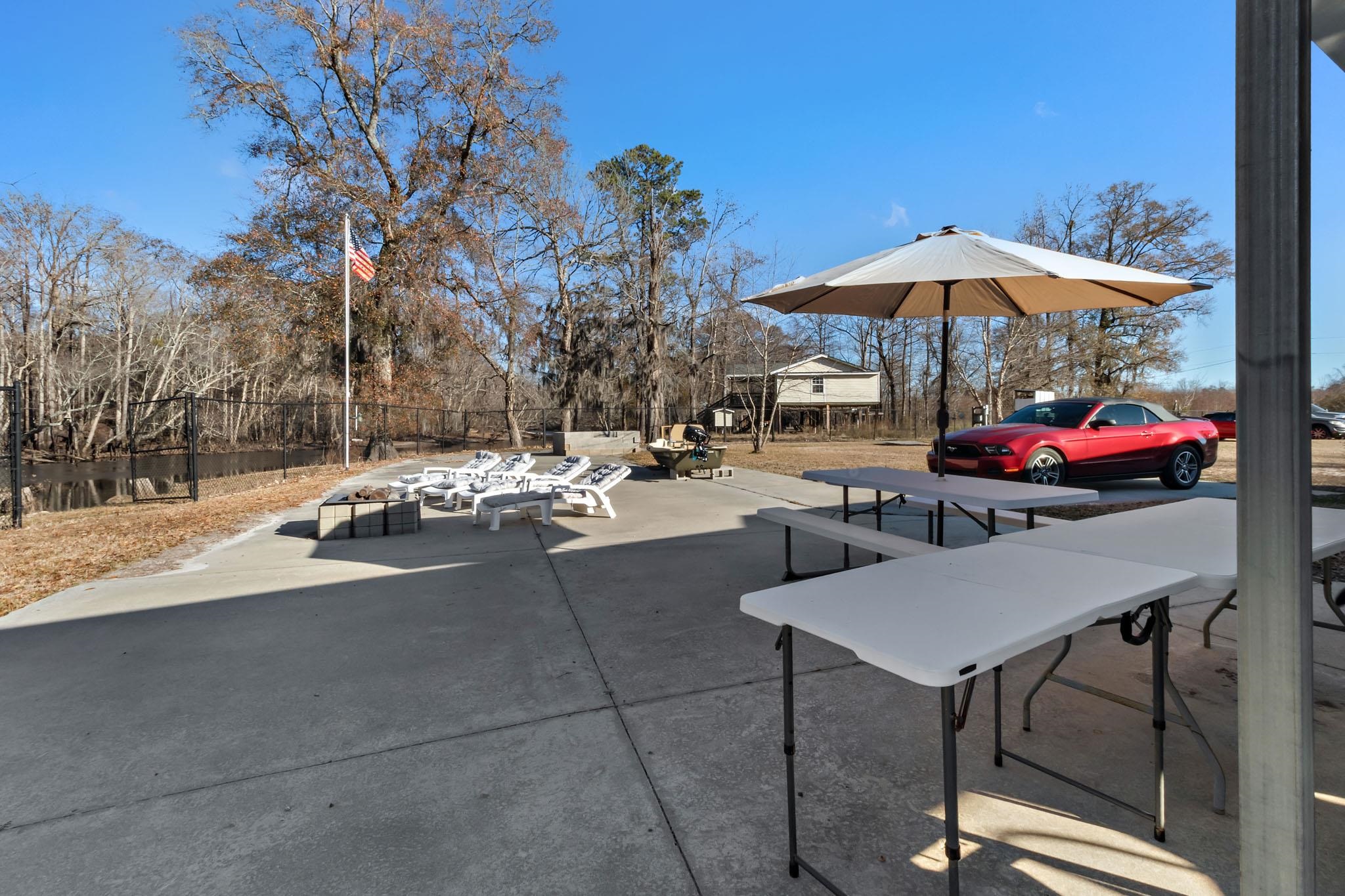 3429 River Road Nichols, SC 29581 - Photo 26 of 26 View of the property featuring fencing, a gazebo and an outbuilding with an outdoor kitchen, bathroom, laundry room, bunk house and firepits