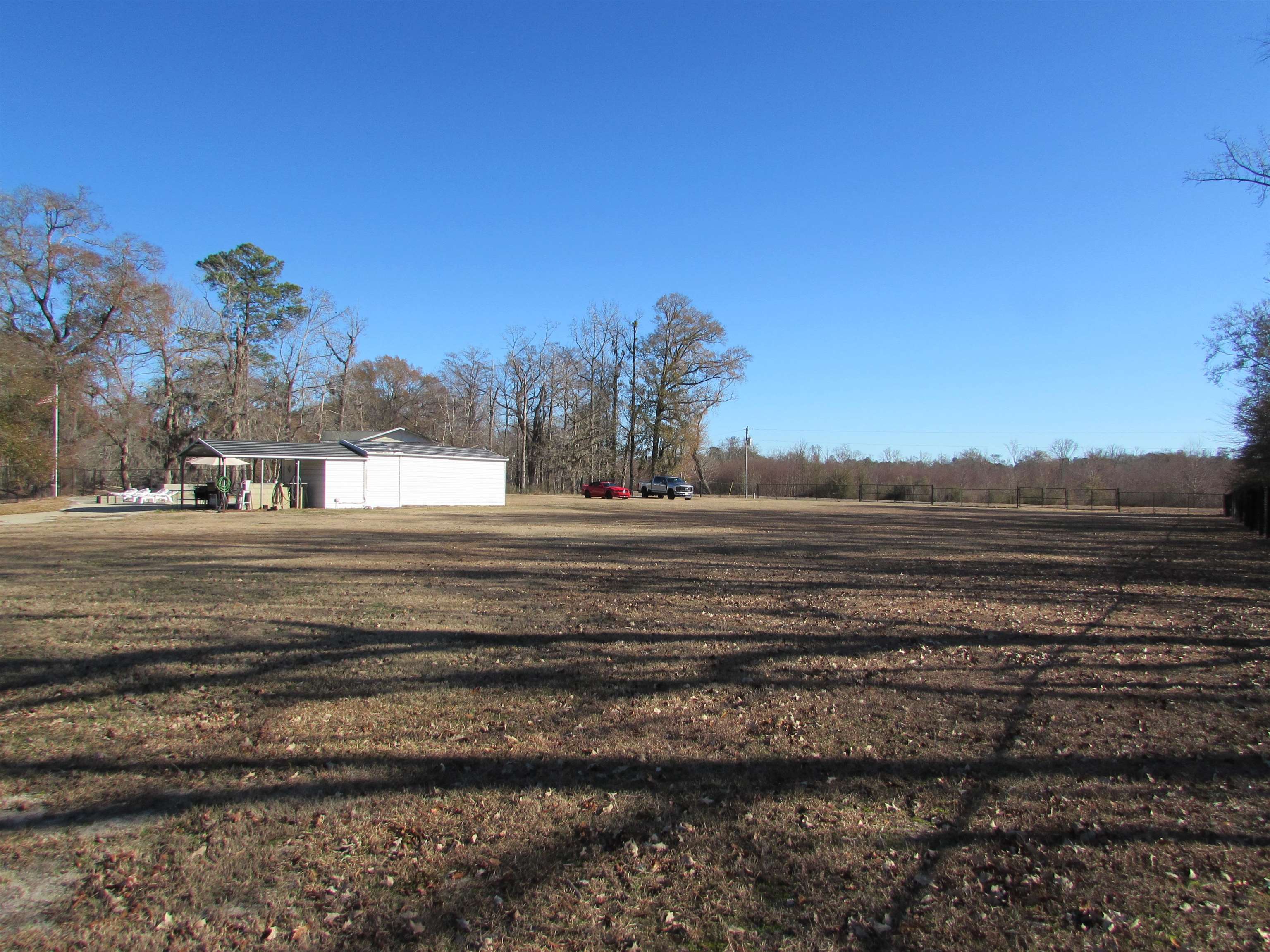 3429 River Road Nichols, SC 29581 - Photo 33 of 46 View from inside the fence and towards the river and the building