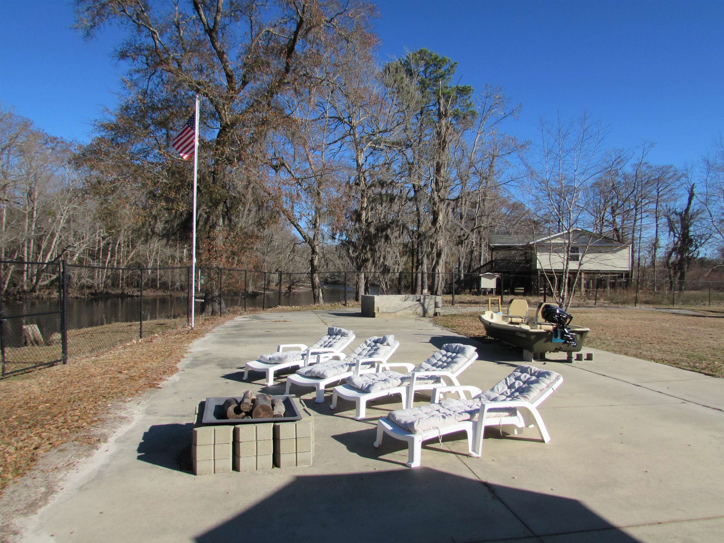 3429 River Road Nichols, SC 29581 - Photo 35 of 46 Large concrete patio area with seating and firepit
