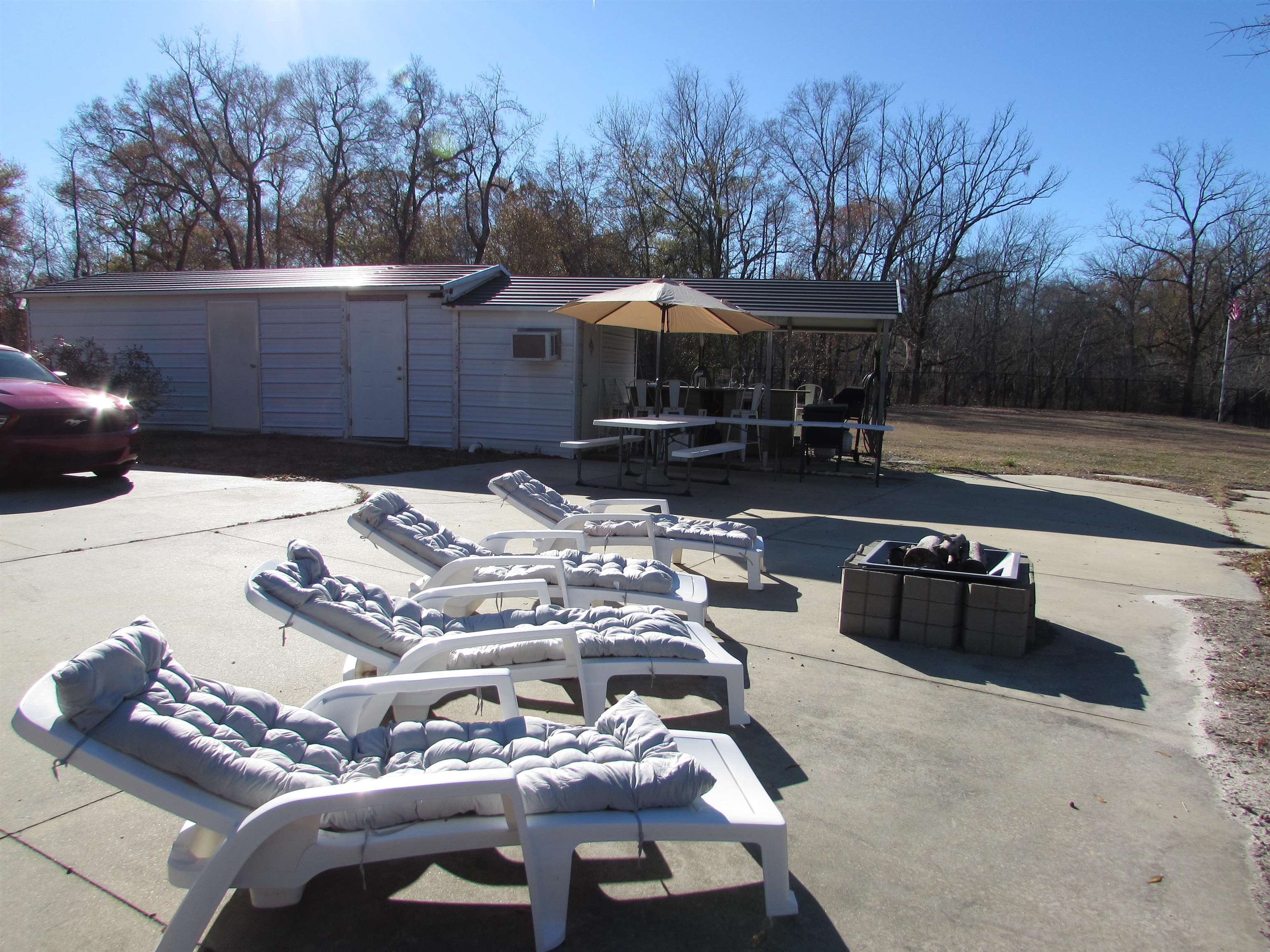 3429 River Road Nichols, SC 29581 - Photo 40 of 46 Large patio area with loungers, firepit and building in the background