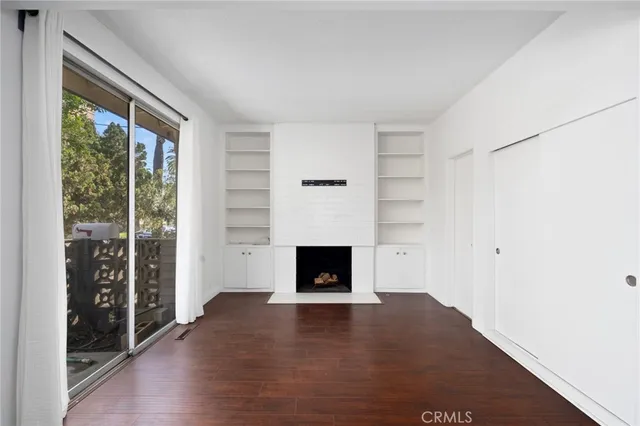wooden floor fireplace and windows in a room