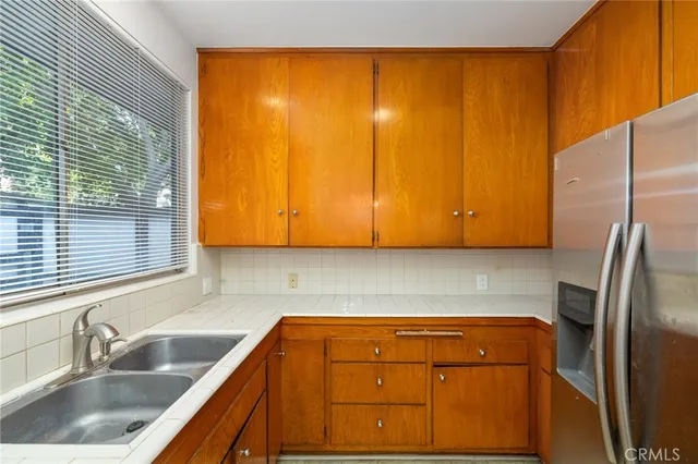 a kitchen with a sink and a refrigerator