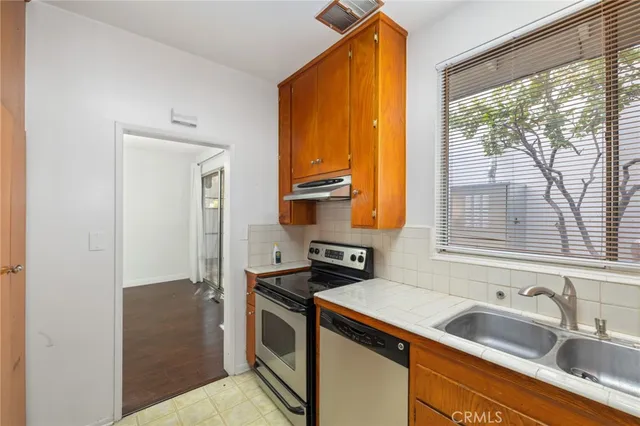 a kitchen that has a sink and a stove