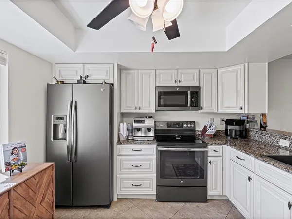 a kitchen with stainless steel appliances a refrigerator stove and microwave