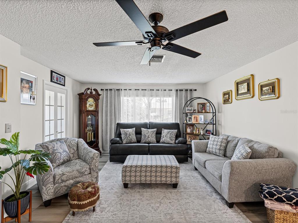 9615 Midiron Court, Unit 9615 New Port Richey, FL 34655 - Photo 17 of 36 a living room with furniture and a window