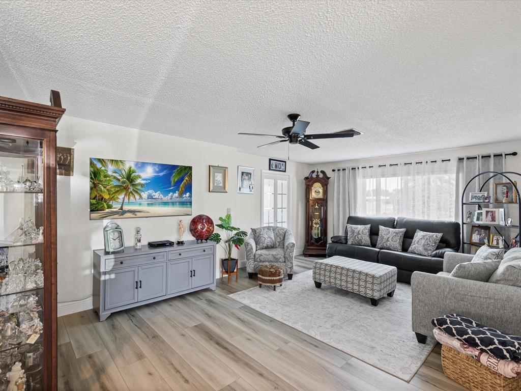 9615 Midiron Court, Unit 9615 New Port Richey, FL 34655 - Photo 19 of 36 a living room with furniture and a flat screen tv