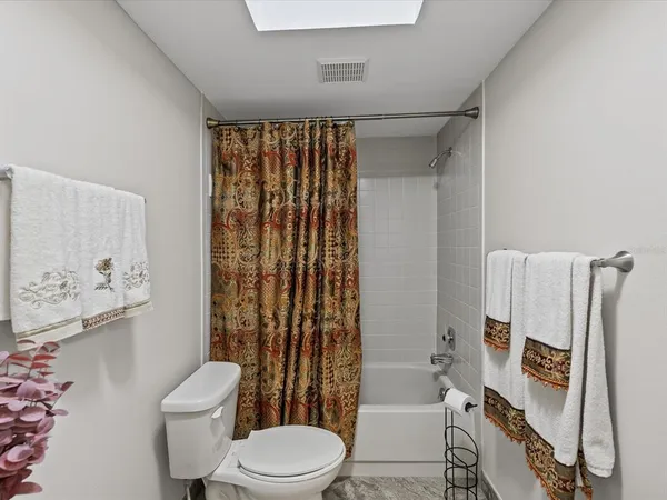 a bathroom with a toilet sink and shower