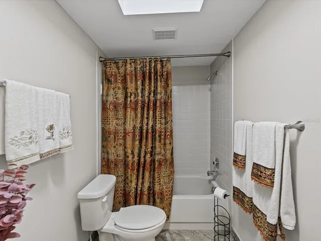 a bathroom with a toilet sink and shower