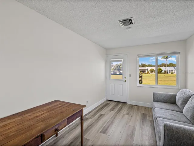 a view of room with window and wooden floor