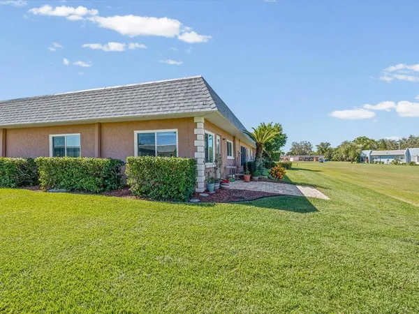 a view of a house with a yard and a porch