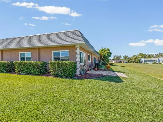 a view of a house with a yard and a porch