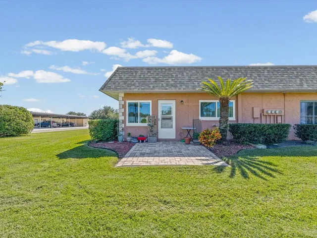 a view of an house with backyard and outdoor seating
