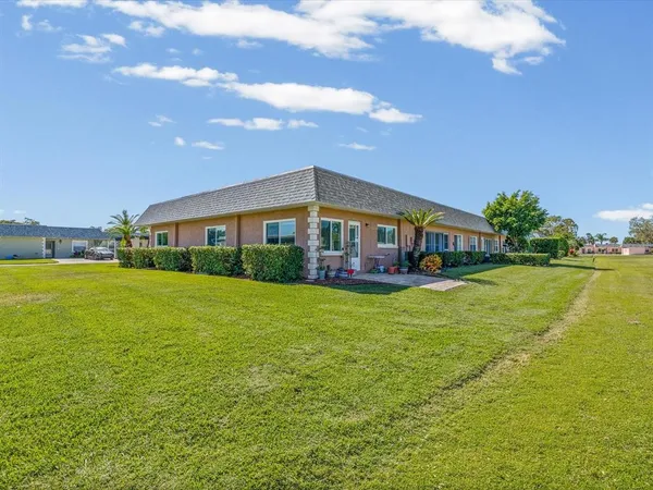 a front view of house with yard and lake view