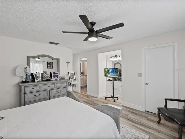 a bedroom with a bed and a chandelier