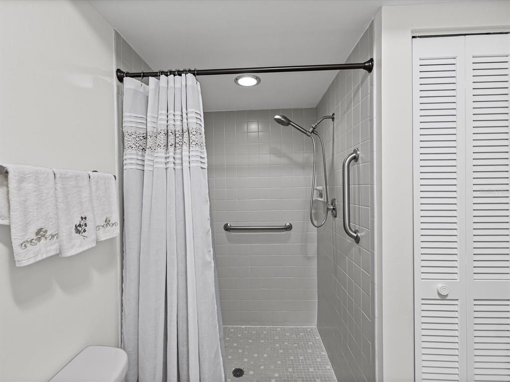 9615 Midiron Court, Unit 9615 New Port Richey, FL 34655 - Photo 7 of 36 a bathroom with a shower and a toilet