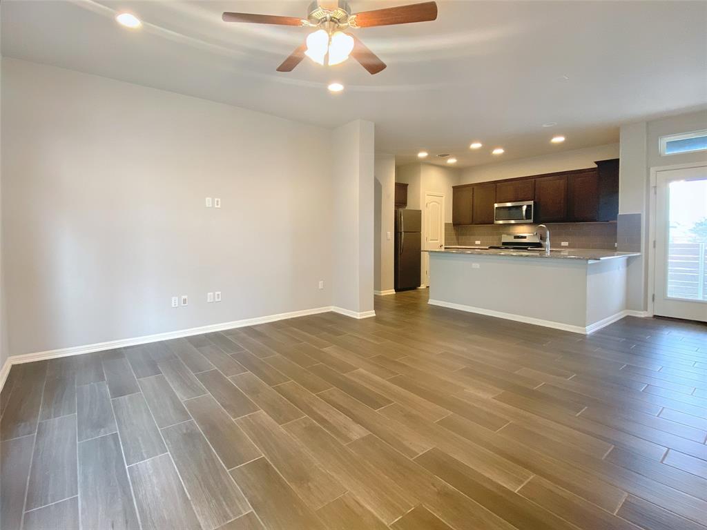 8901 Panhandle Drive Austin, TX 78747 - Photo 7 of 21 Spacious room with wood-finish tile flooring, recessed lighting, and a ceiling fan