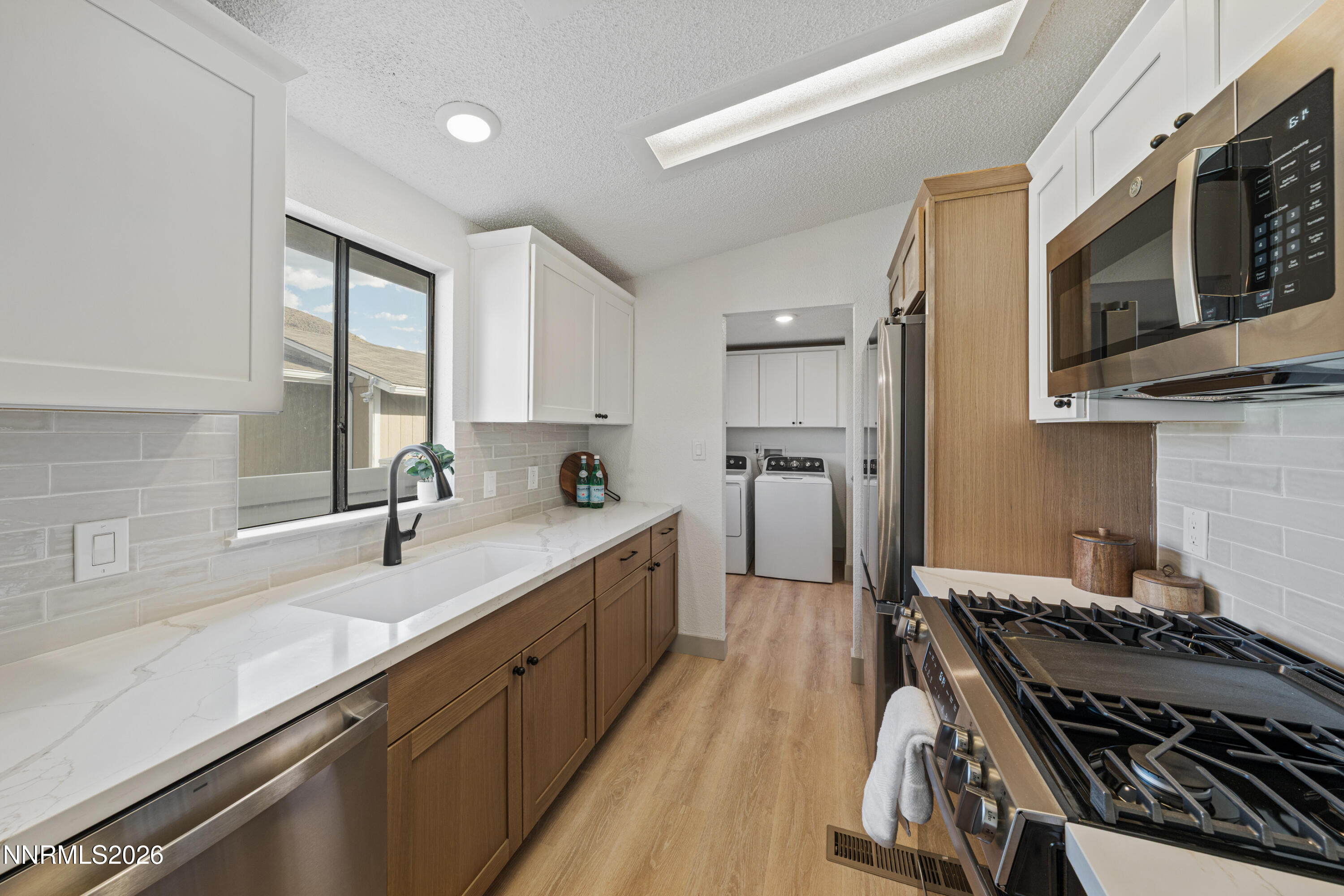 239 Rue De La Chartreuse Sparks, NV 89434 - Photo 2 of 24 a kitchen with stainless steel appliances a sink stove and cabinets