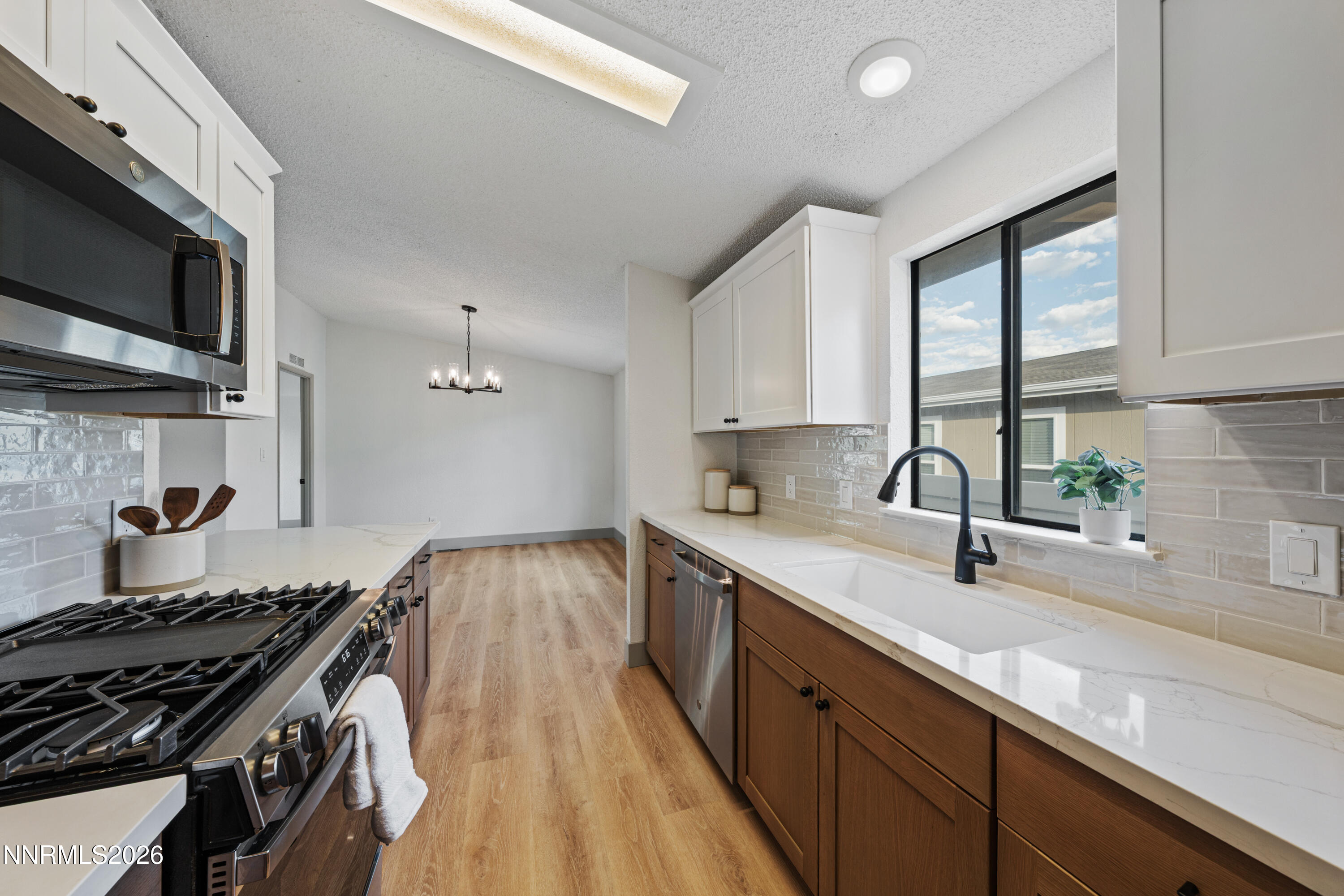 239 Rue De La Chartreuse Sparks, NV 89434 - Photo 8 of 24 a kitchen with stainless steel appliances granite countertop a sink stove and microwave