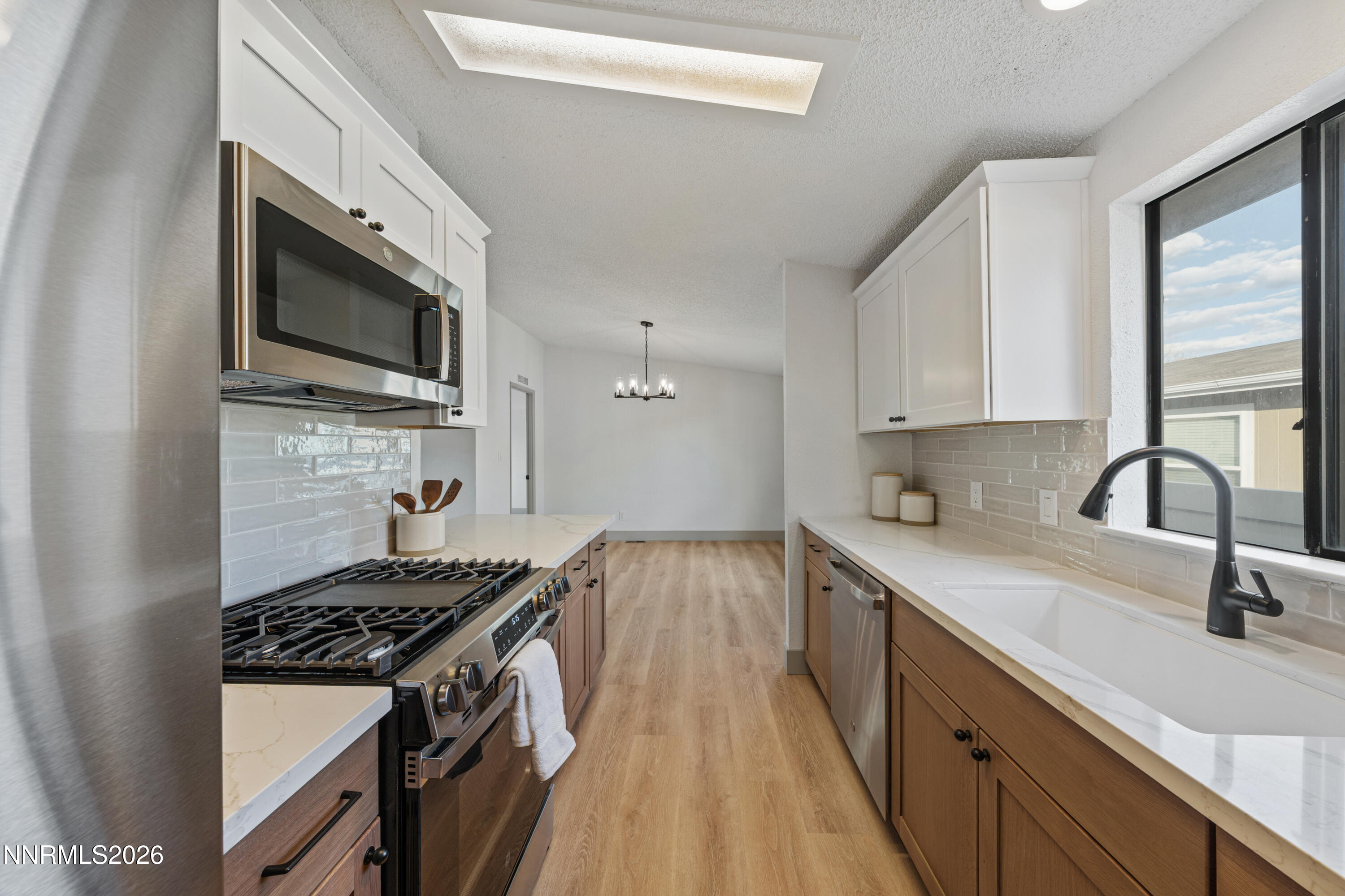 239 Rue De La Chartreuse Sparks, NV 89434 - Photo 9 of 24 a kitchen with a sink stove top oven and cabinets