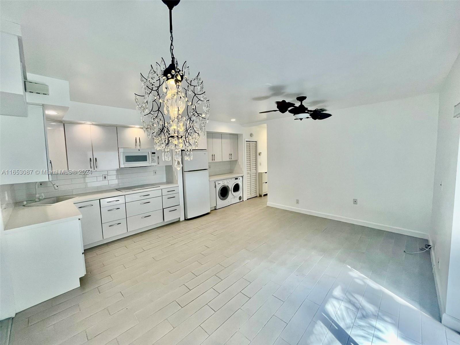 3475 Southwest 1st Avenue, Unit 7 Miami, FL 33145 - Photo 1 of 17 a kitchen with white cabinets and window