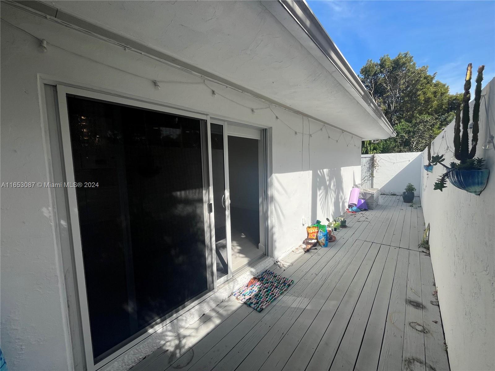 3475 Southwest 1st Avenue, Unit 7 Miami, FL 33145 - Photo 12 of 17 a view of a porch with wooden floor and stairs