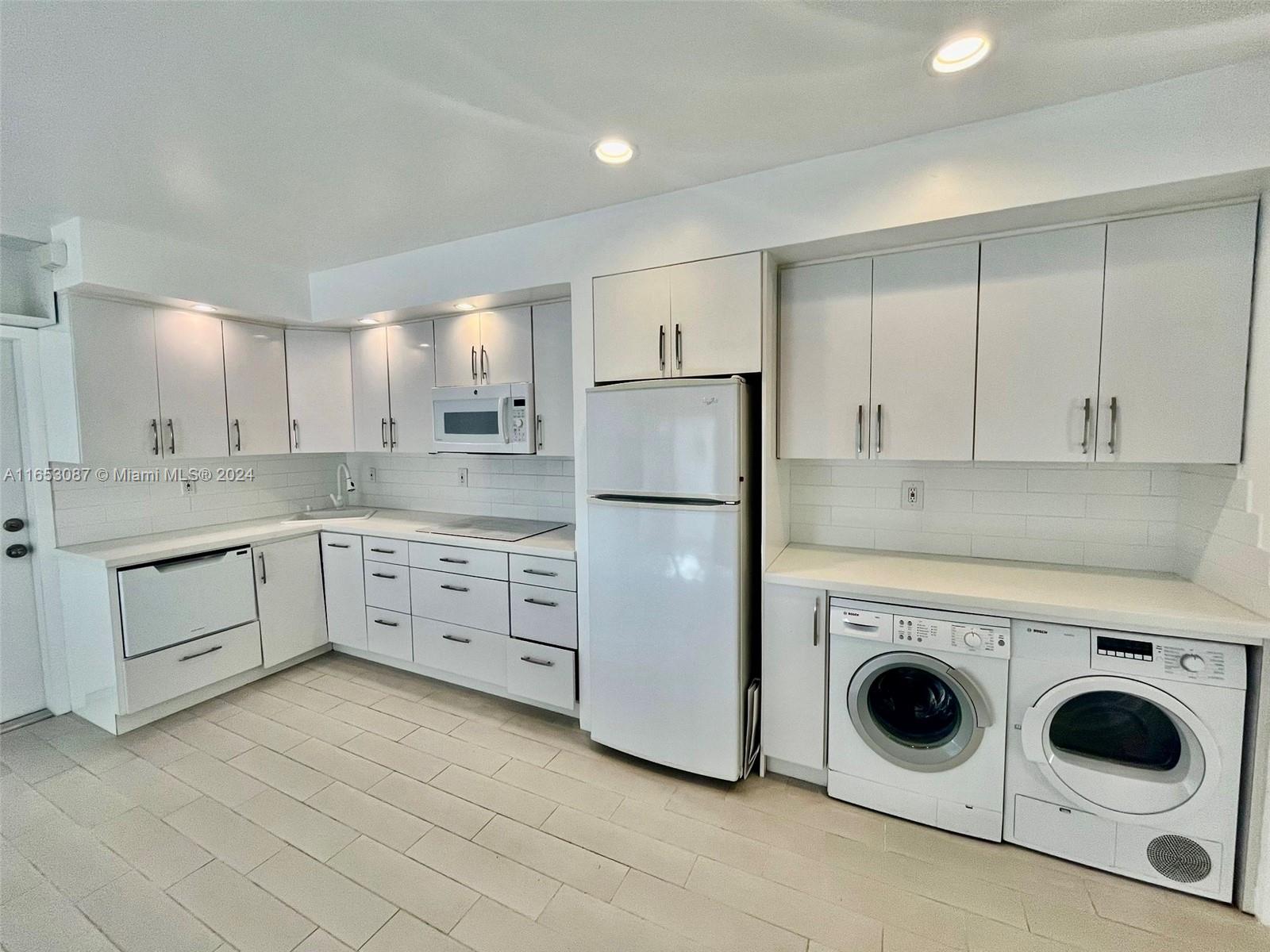 3475 Southwest 1st Avenue, Unit 7 Miami, FL 33145 - Photo 3 of 17 a kitchen with white cabinets white stainless steel appliances and sink