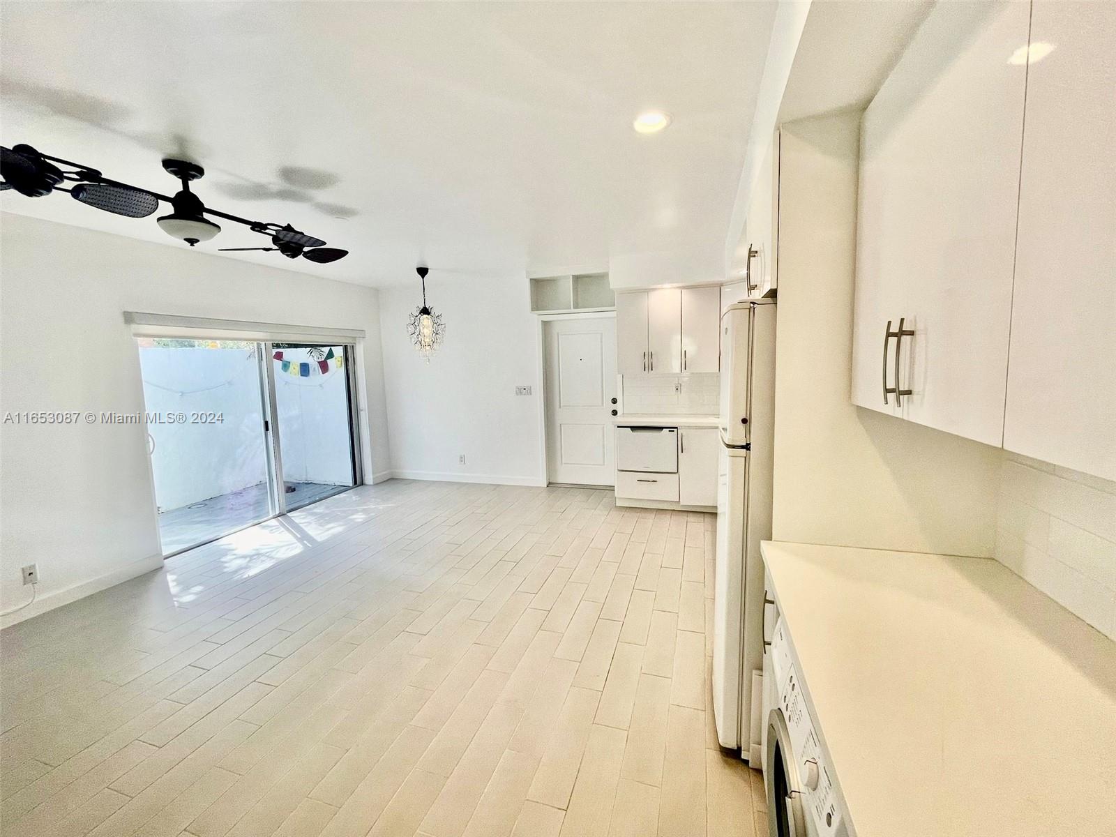3475 Southwest 1st Avenue, Unit 7 Miami, FL 33145 - Photo 4 of 17 a view of a kitchen with a refrigerator and a stove top oven