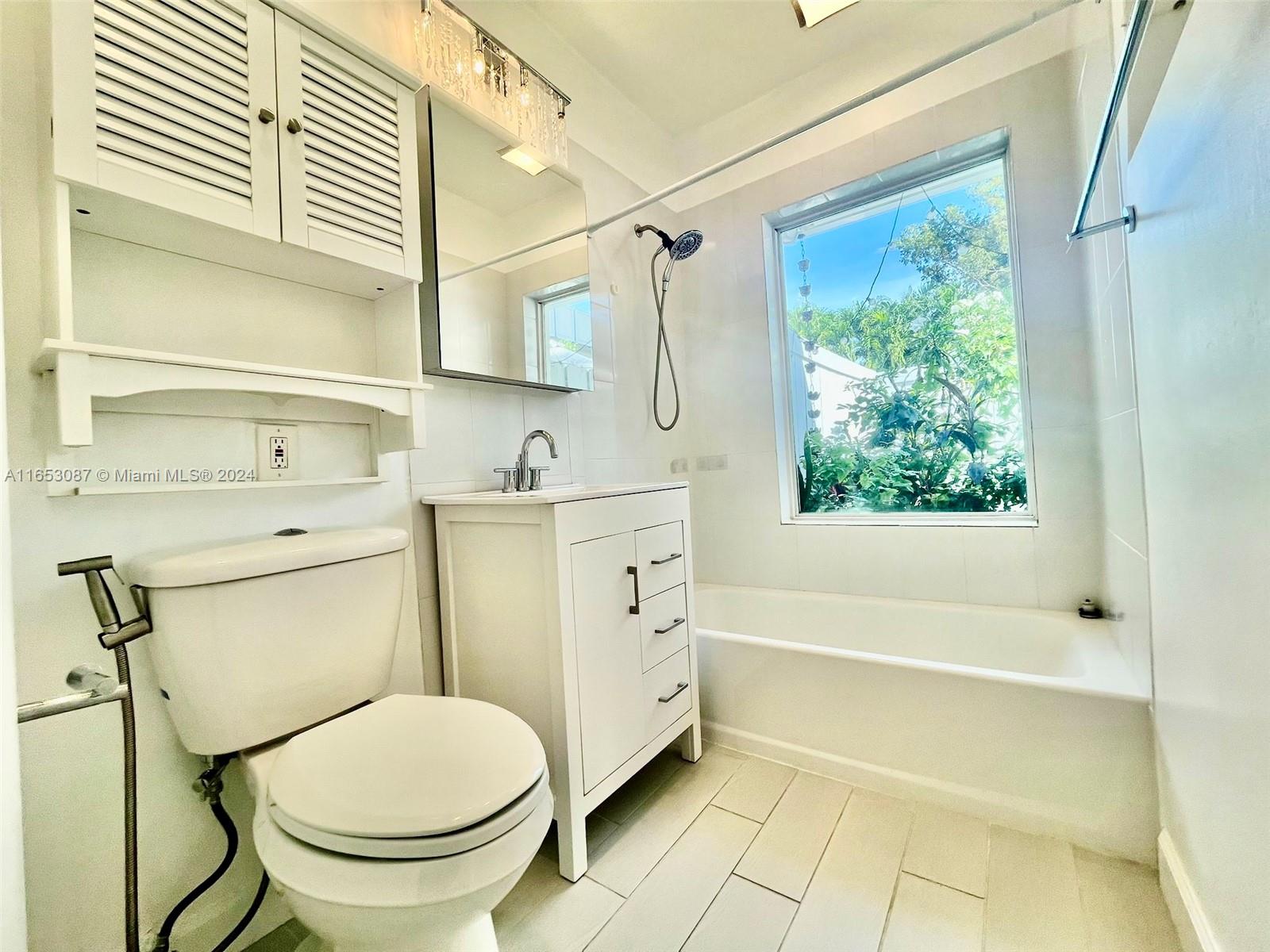 3475 Southwest 1st Avenue, Unit 7 Miami, FL 33145 - Photo 6 of 17 a bathroom with a toilet sink and bathtub