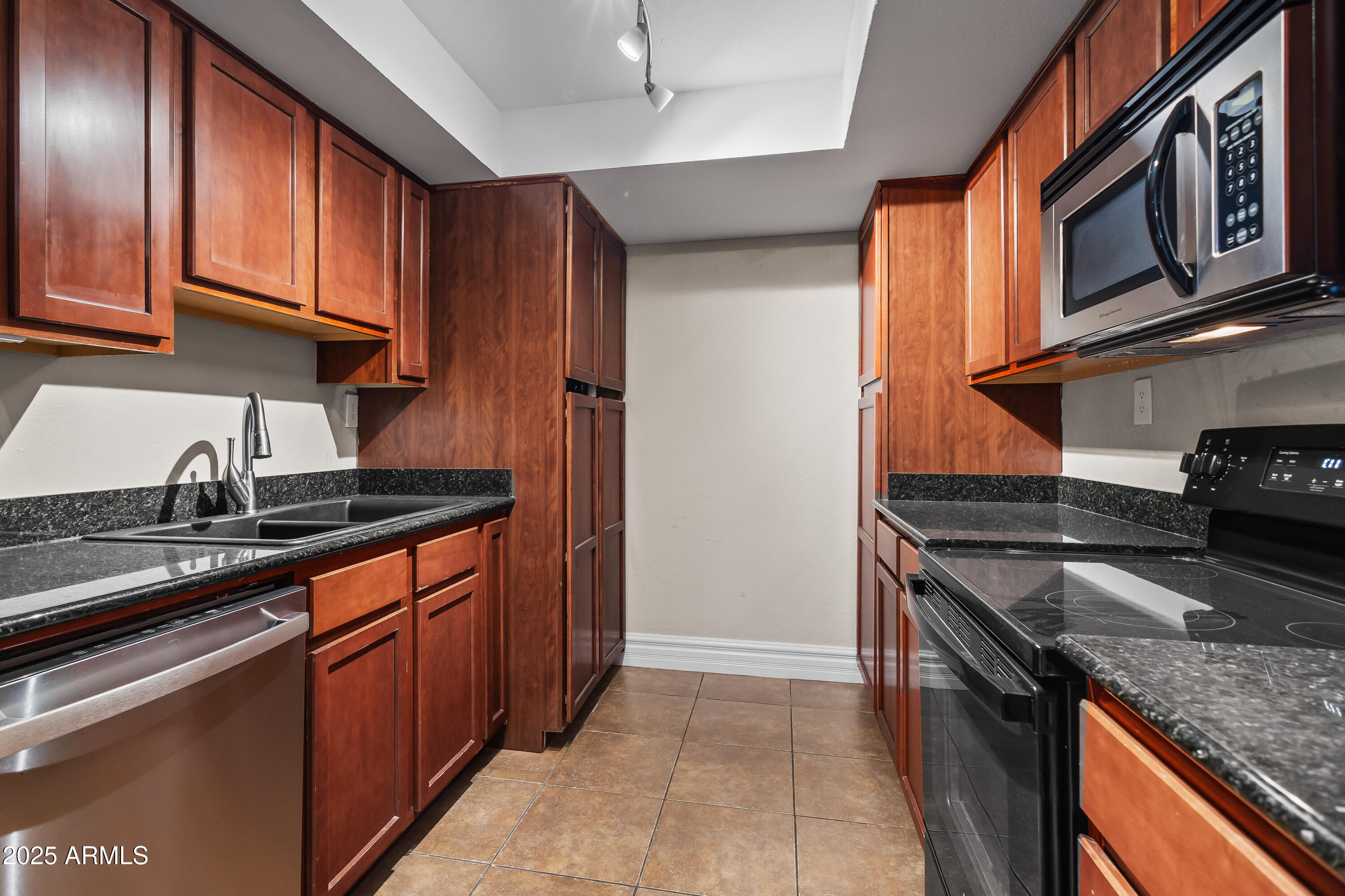 3825 East Camelback Road, Unit 114 Phoenix, AZ 85018 - Photo 12 of 21 a kitchen with stainless steel appliances granite countertop a stove and a sink