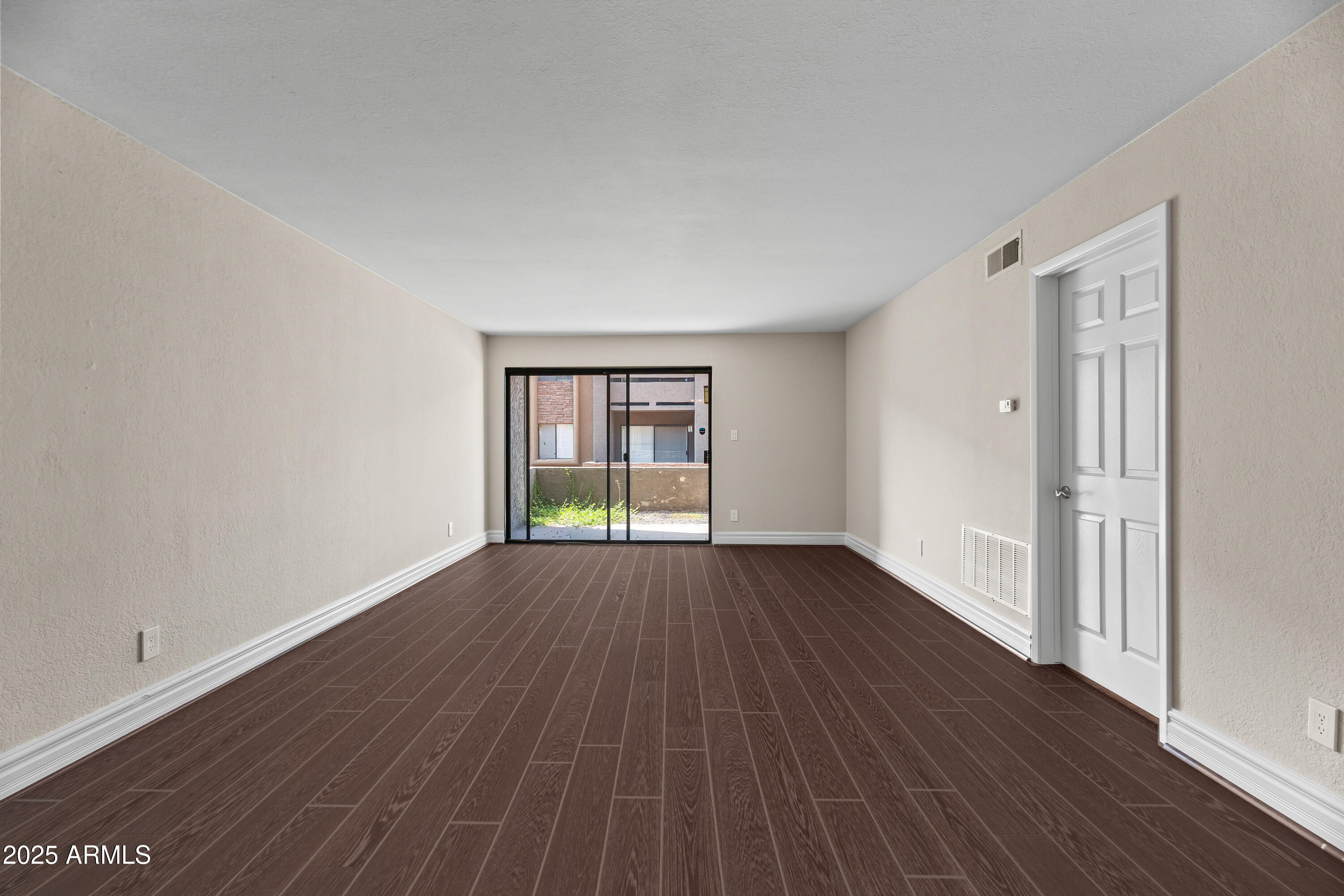 3825 East Camelback Road, Unit 114 Phoenix, AZ 85018 - Photo 13 of 21 a view of an empty room with wooden floor and window
