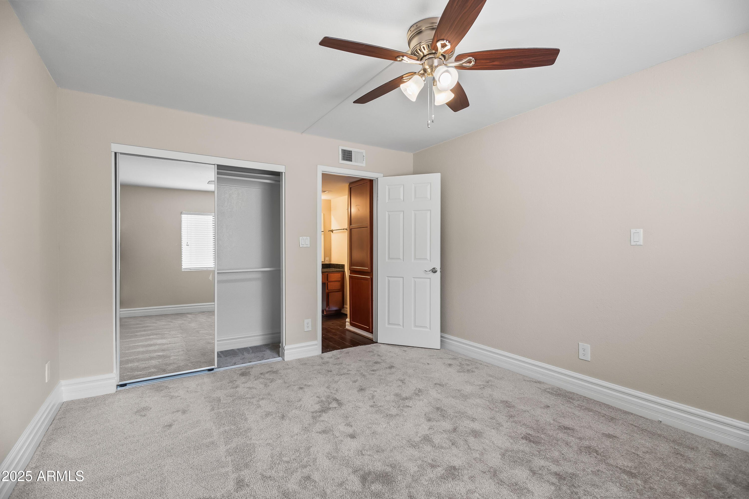 3825 East Camelback Road, Unit 114 Phoenix, AZ 85018 - Photo 17 of 21 an empty room with closet and a ceiling fan