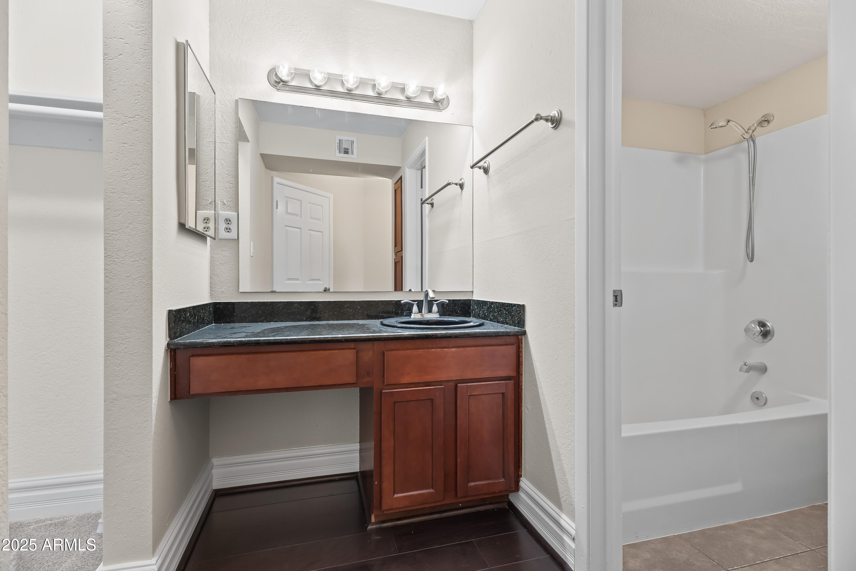 3825 East Camelback Road, Unit 114 Phoenix, AZ 85018 - Photo 18 of 21 a bathroom with a sink and a mirror