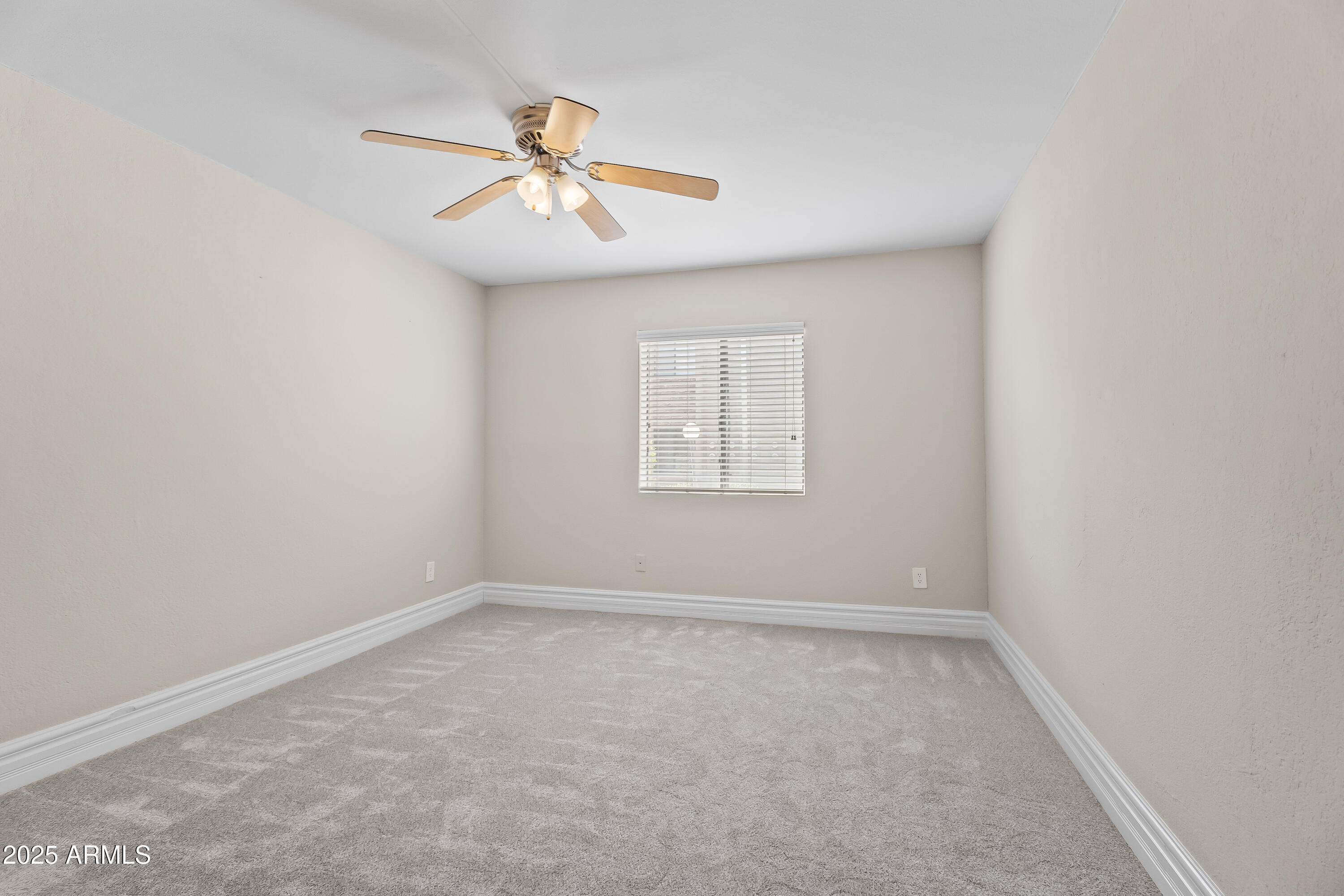 3825 East Camelback Road, Unit 114 Phoenix, AZ 85018 - Photo 21 of 21 an empty room with a window and a fan