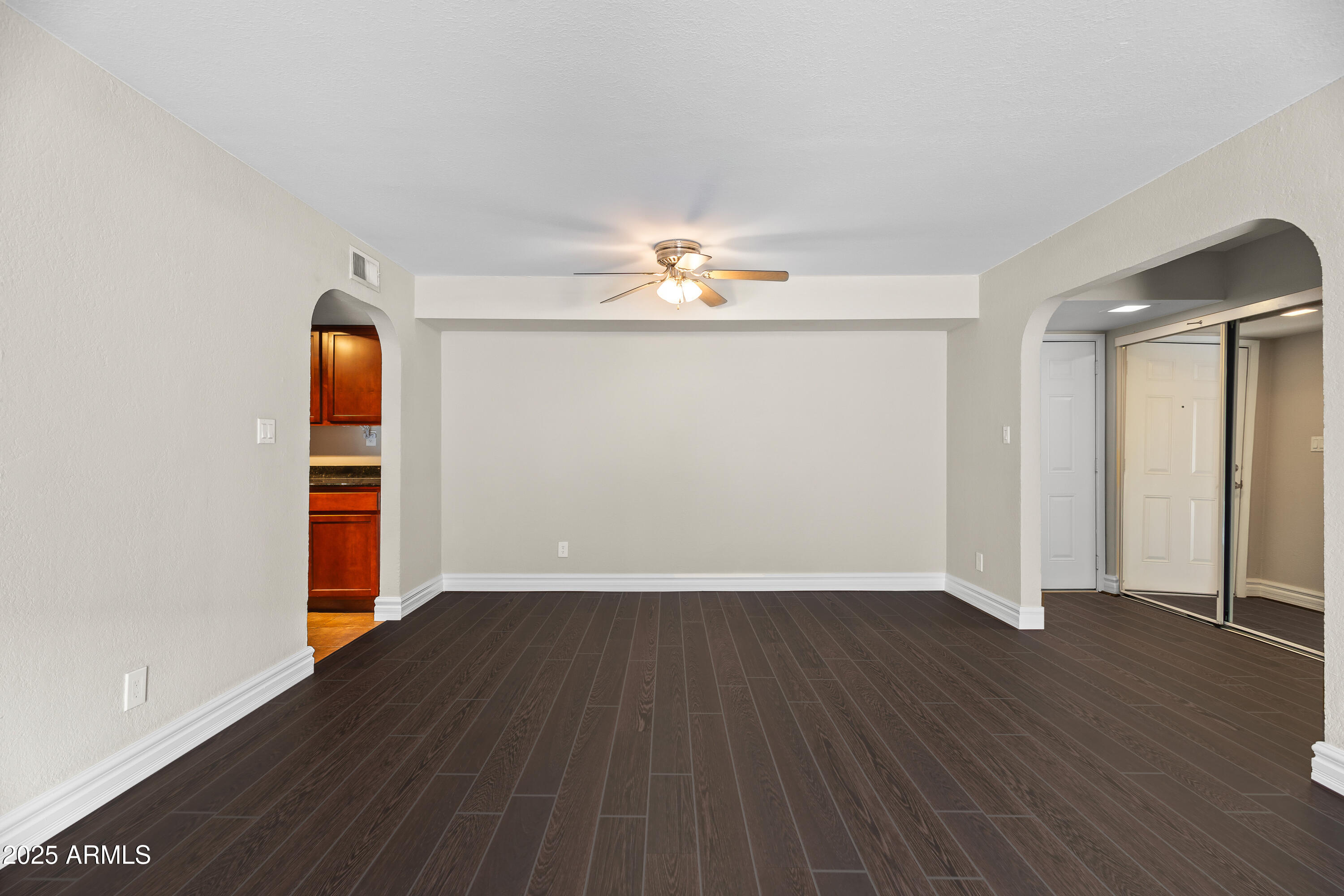 3825 East Camelback Road, Unit 114 Phoenix, AZ 85018 - Photo 6 of 21 wooden floor in an empty room with a window