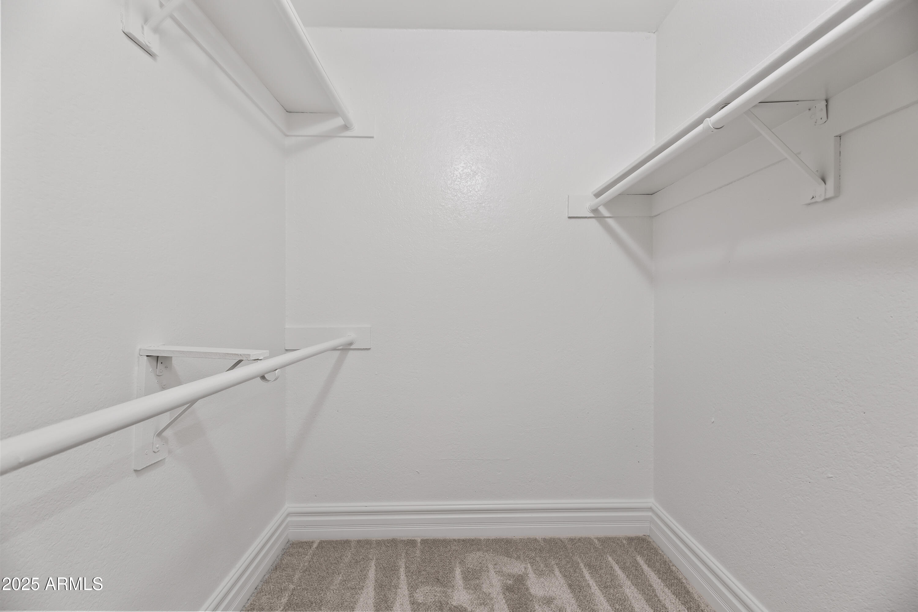 3825 East Camelback Road, Unit 114 Phoenix, AZ 85018 - Photo 9 of 21 a view of walk in closet with empty racks
