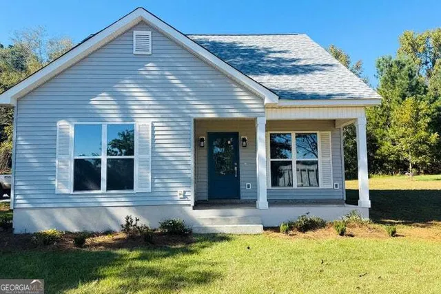 a front view of a house with a yard